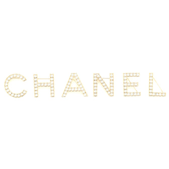 Resin, Enamel and Ruthenium Metal Pin brooch featuring polish coloured  beads and a silver chain charm with classic Chanel logo pendents. Chanel.  2012., Handbags and Accessories Online, Ecommerce Retail