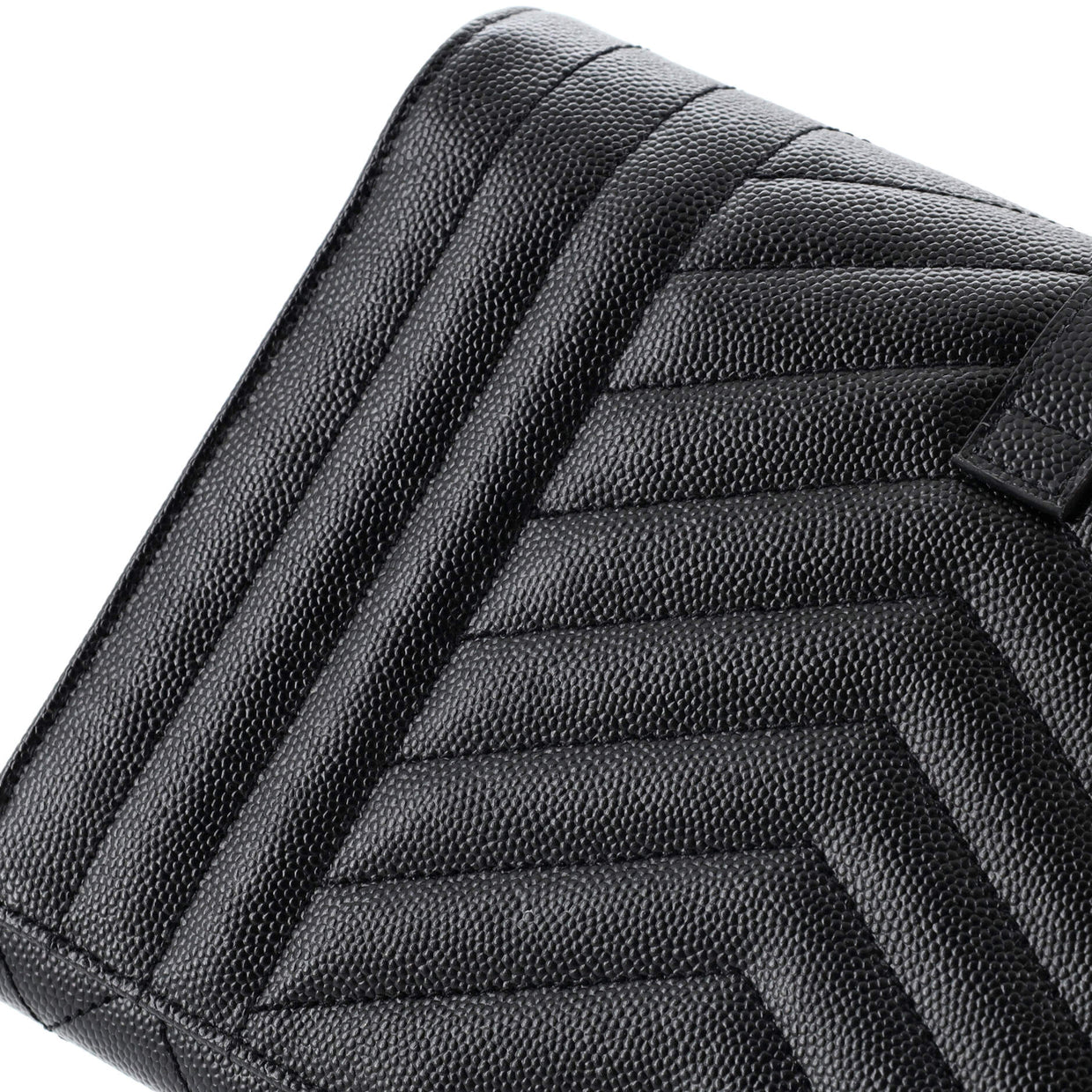 Close-up front view of a black Saint Laurent Cassandre Clutch with chevron quilting and gold YSL hardware.