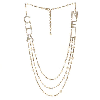 Chanel CHA-NEL Logo Triple Strand Necklace Crystal Embellished Metal and Faux Pearls